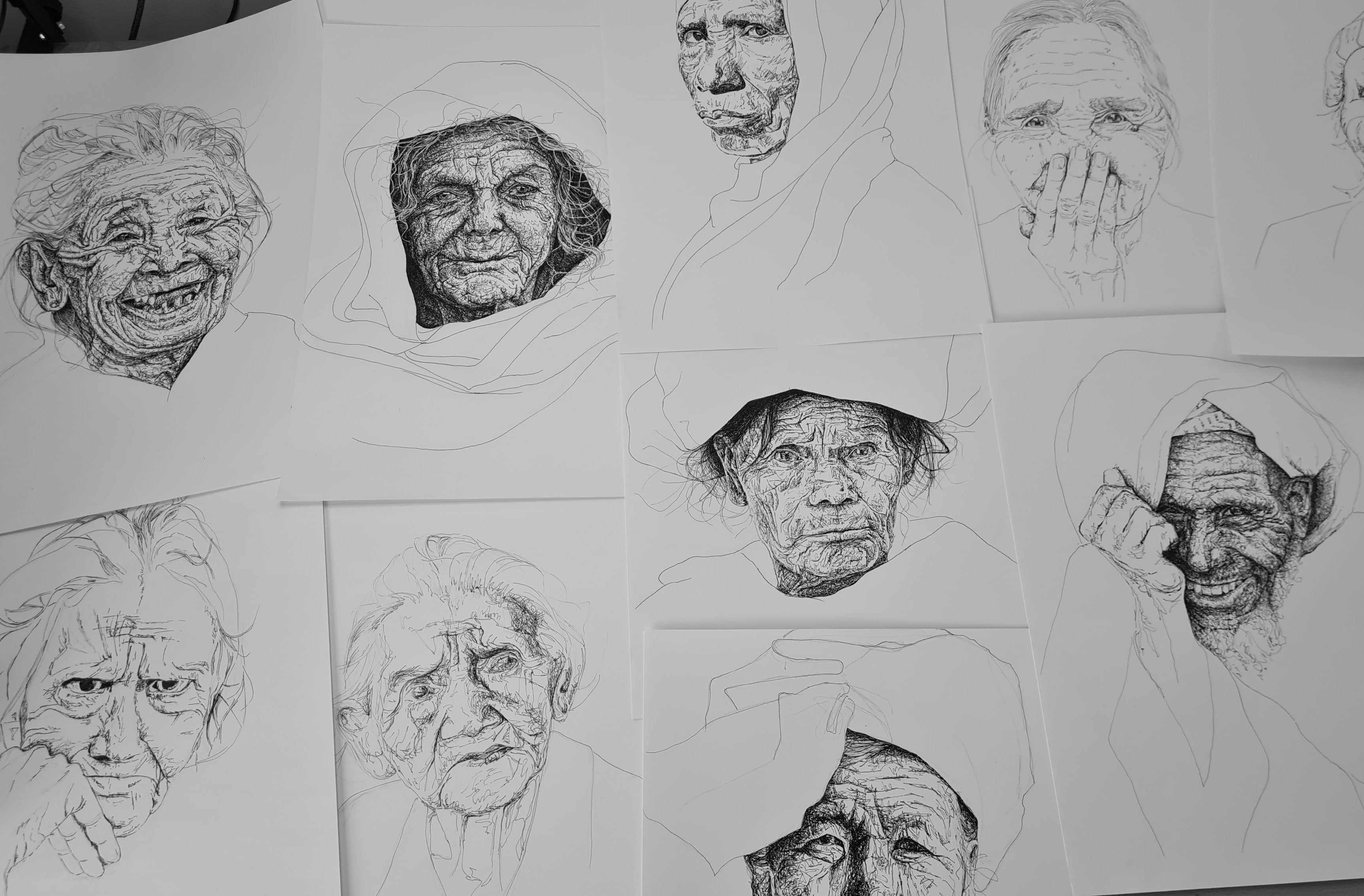 a spread of original portraits drawn in black pen on white paper with a scribbled pen style and minimalist surrounds